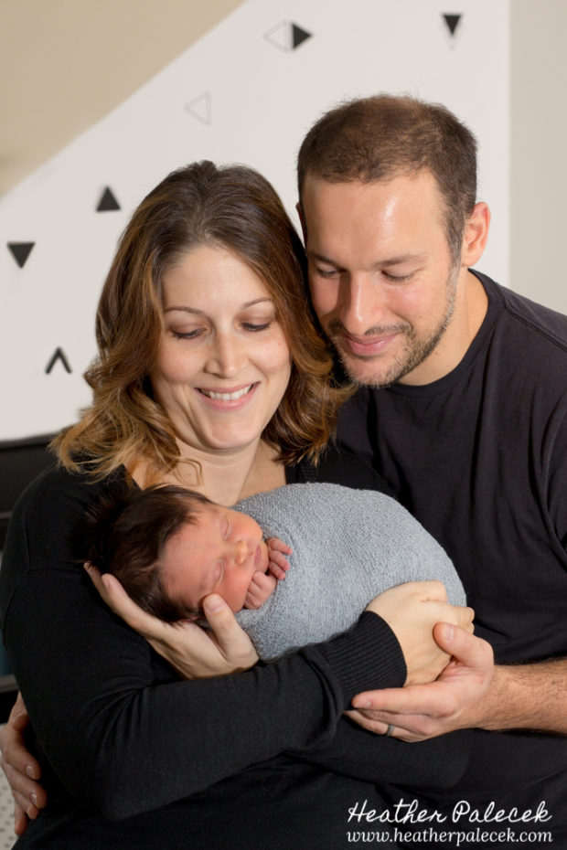 family with newborn in nursery
