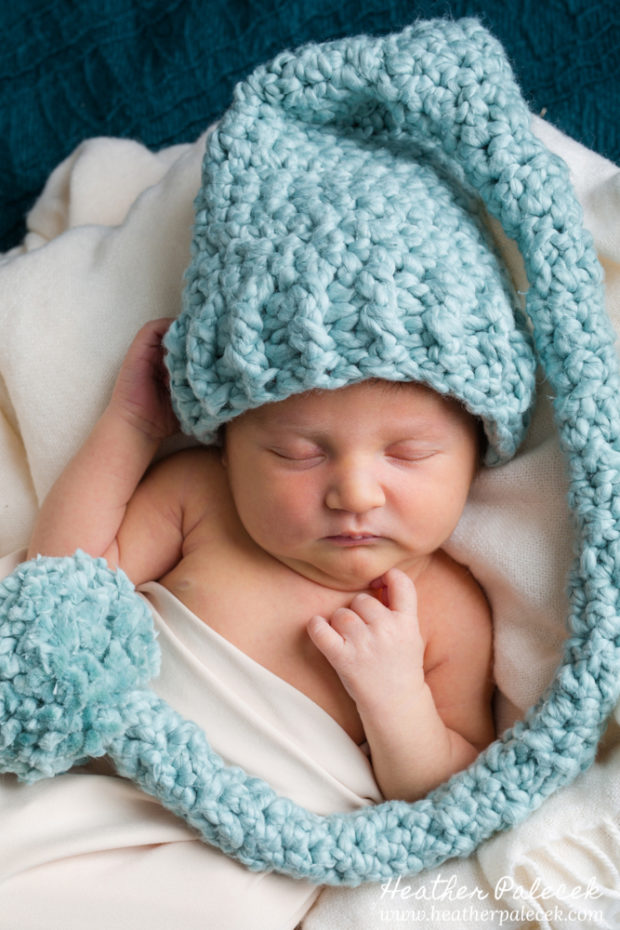 newborn in turquoise hat