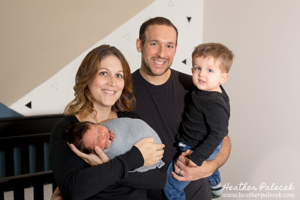family with newborn in nursery