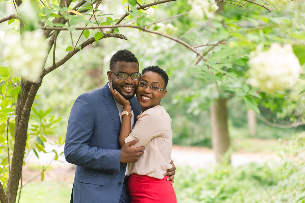 happy couple embracing under tree