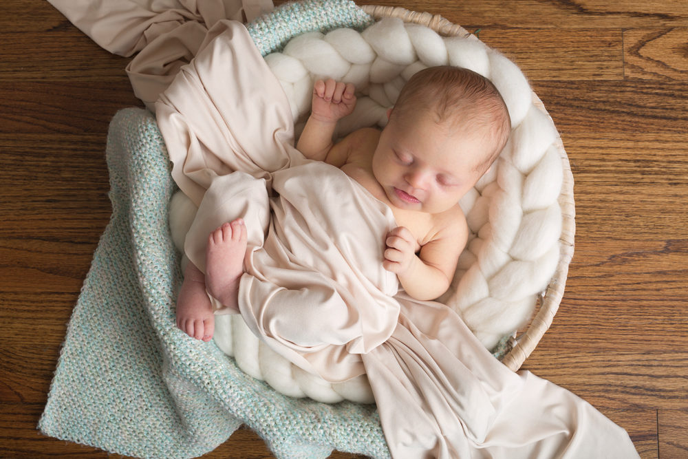 newborn girl in bowl with blanket