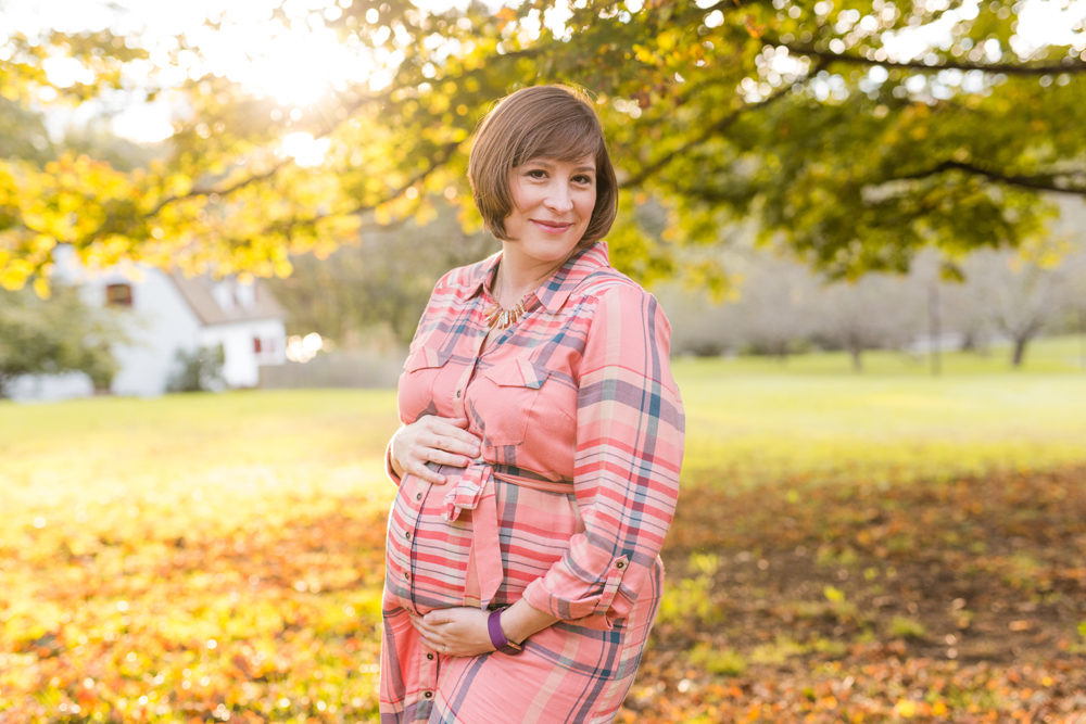 pregnant woman in pink on fall day