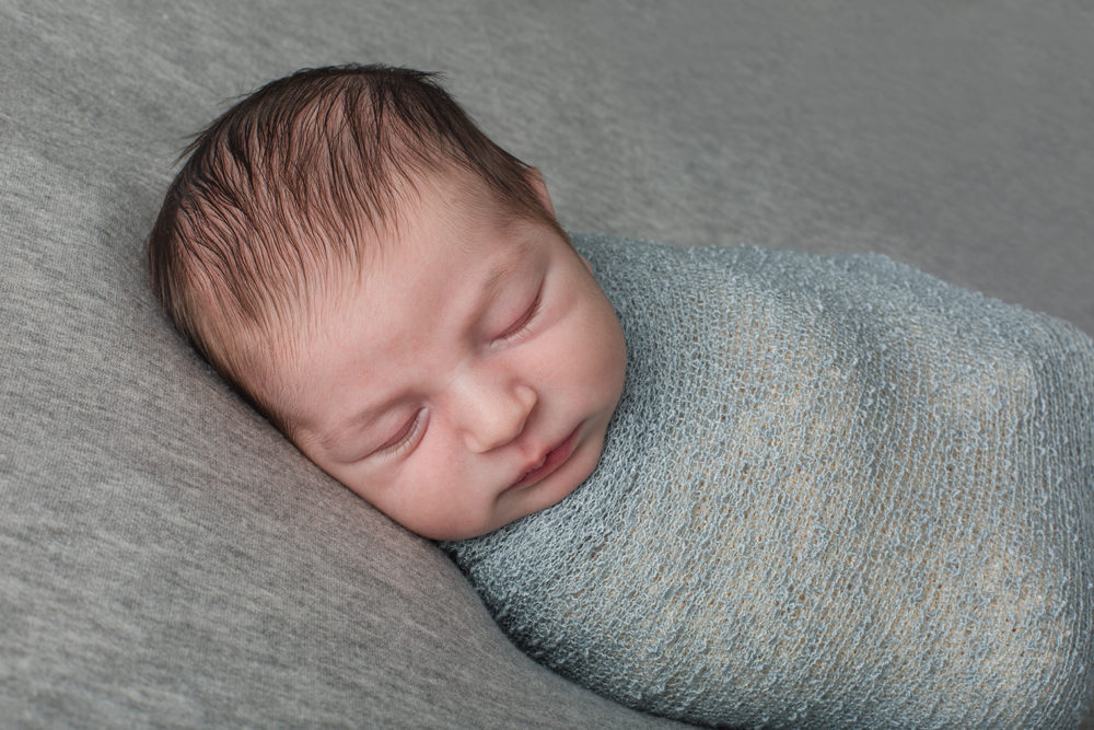 newborn boy in blue and gray