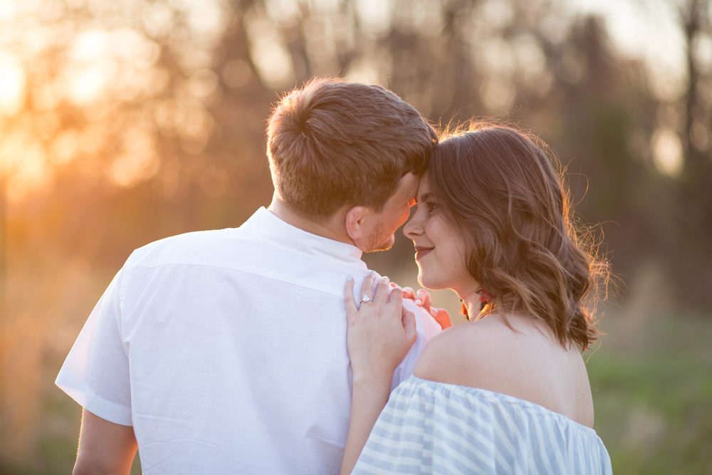 couple pose in golden hour light
