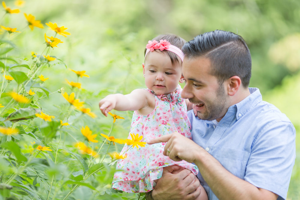 dad and daughter looking at flowers