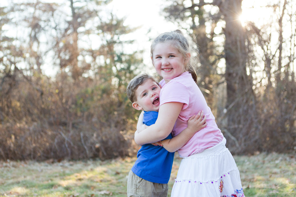 brother and sister hugging