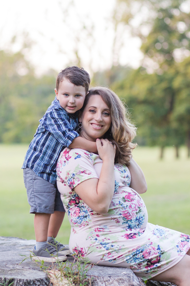 pregnant mom and son pose
