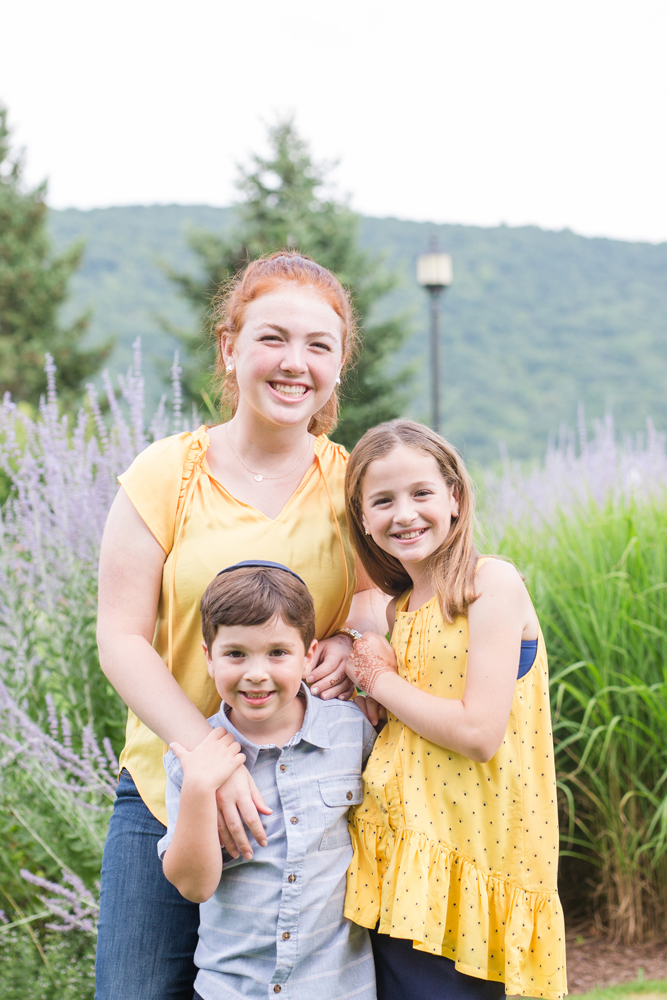 three siblings posing in garden