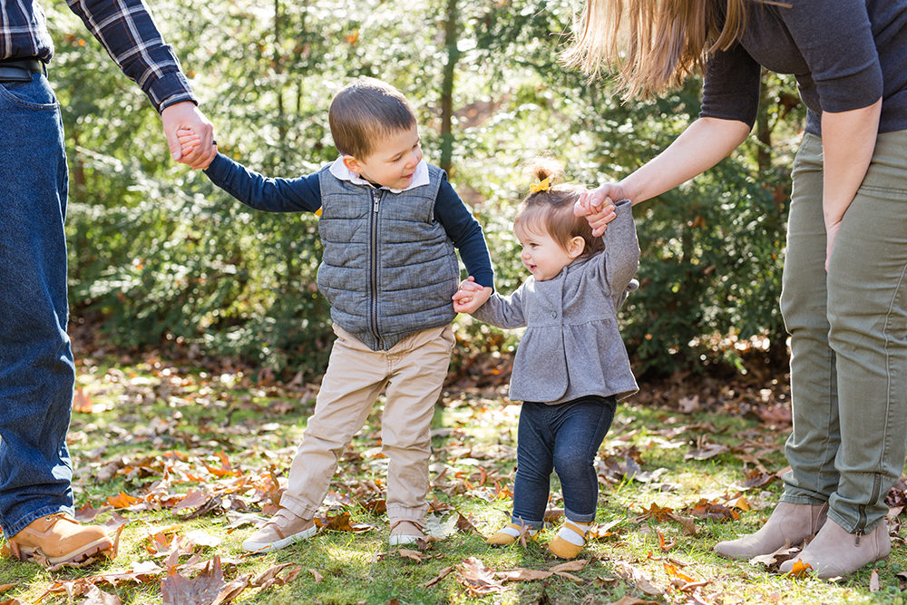 brother and sister hold hands