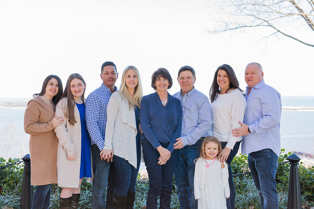 family portrait in front of water