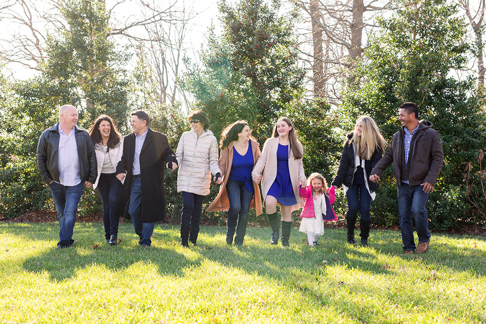 family skipping in field