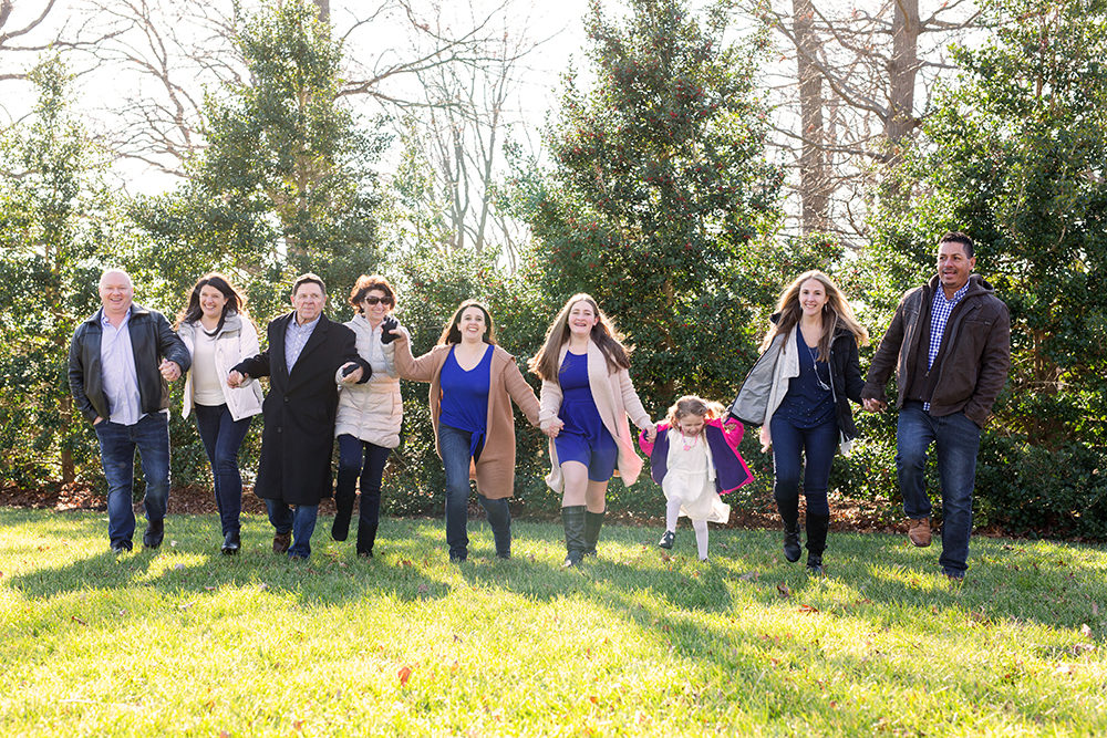 family skipping in field