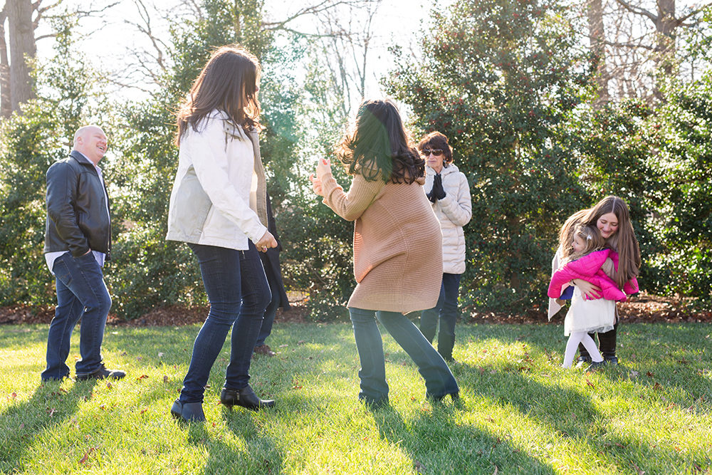 family skipping in field