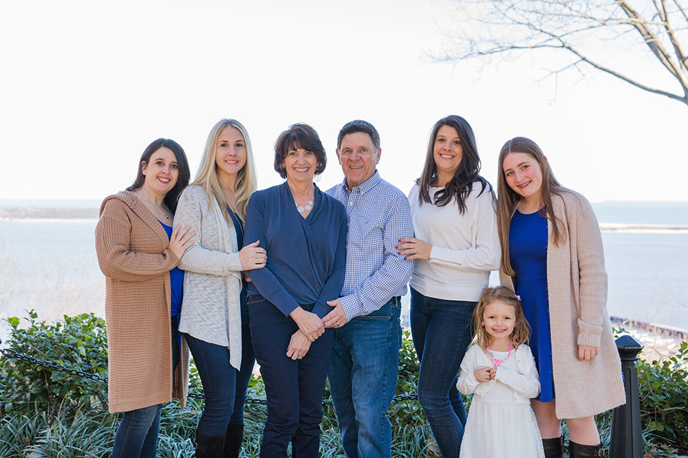 family portrait in front of water
