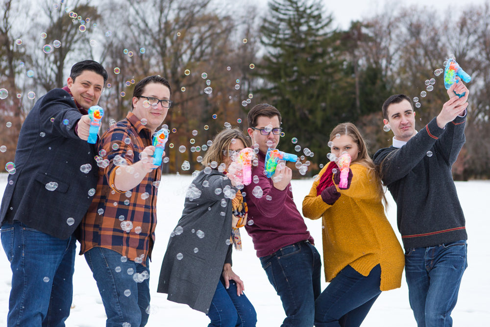 Family playing with bubble guns