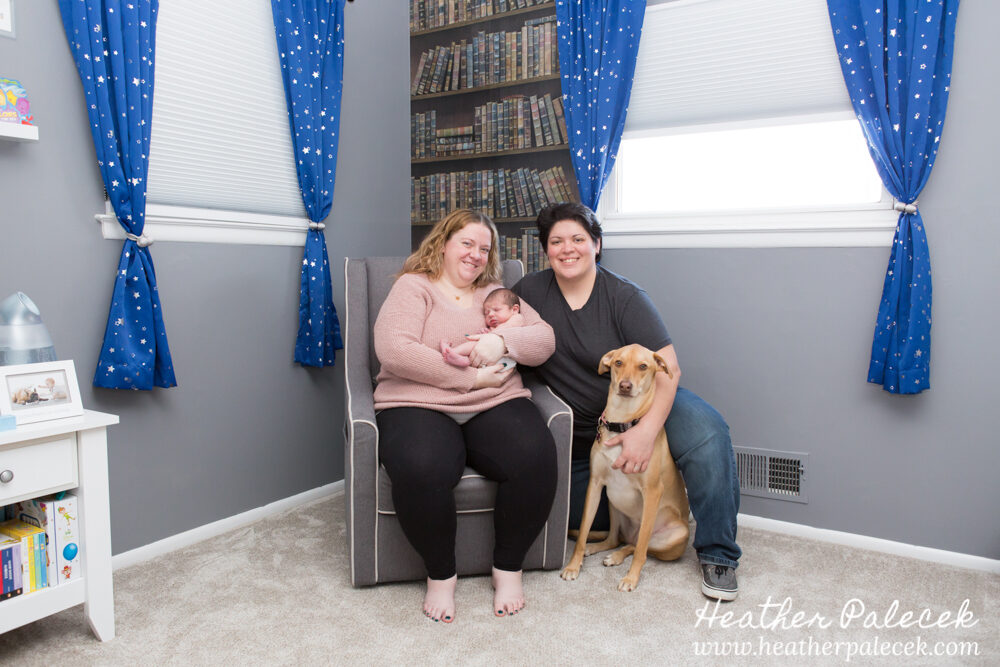 family portrait with newborn in nursery