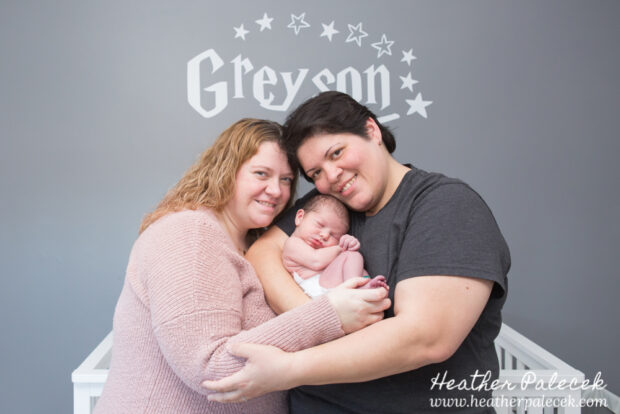 family portrait with newborn in nursery