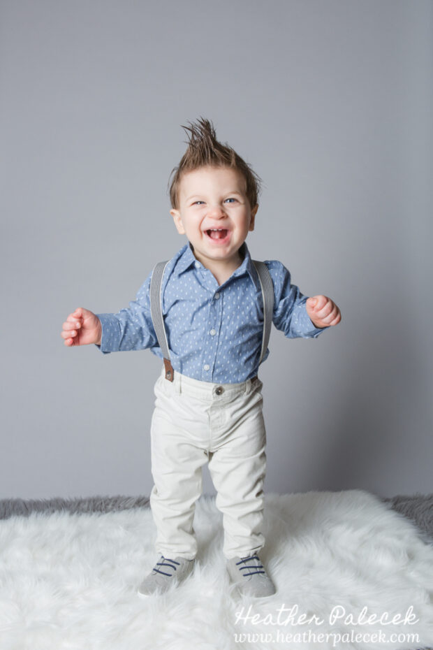 first birthday portrait of boy in blue button down