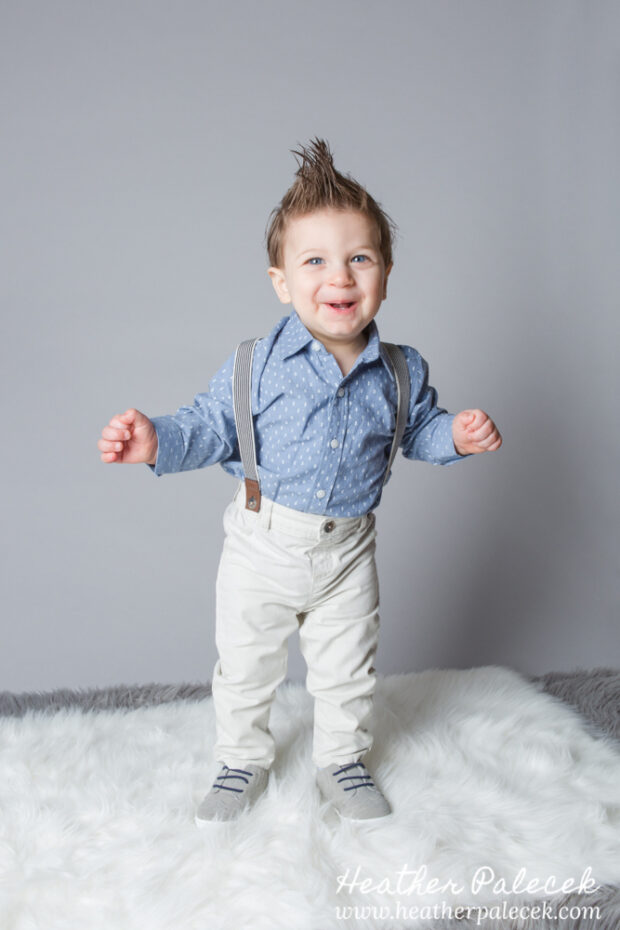 first birthday portrait of boy in blue button down