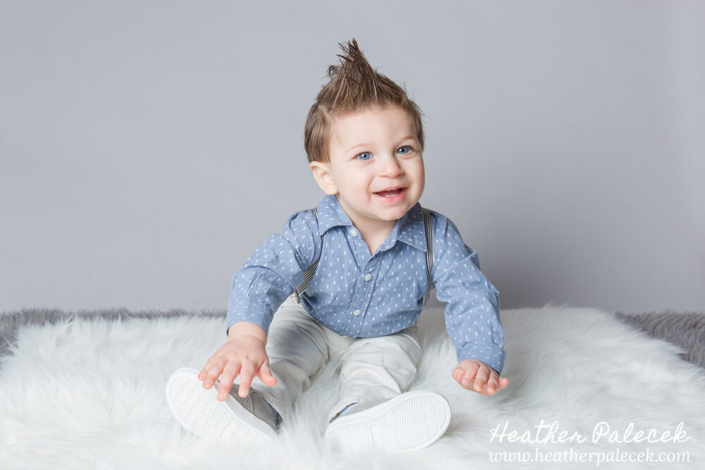 first birthday portrait of boy in blue button down