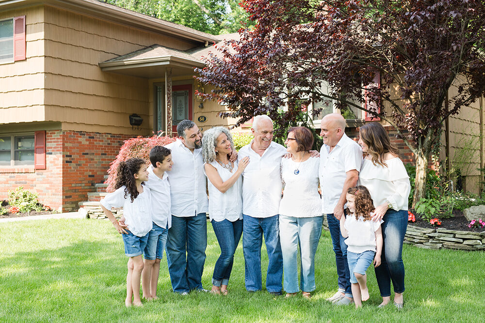 9 family members pose in front of grandparents house