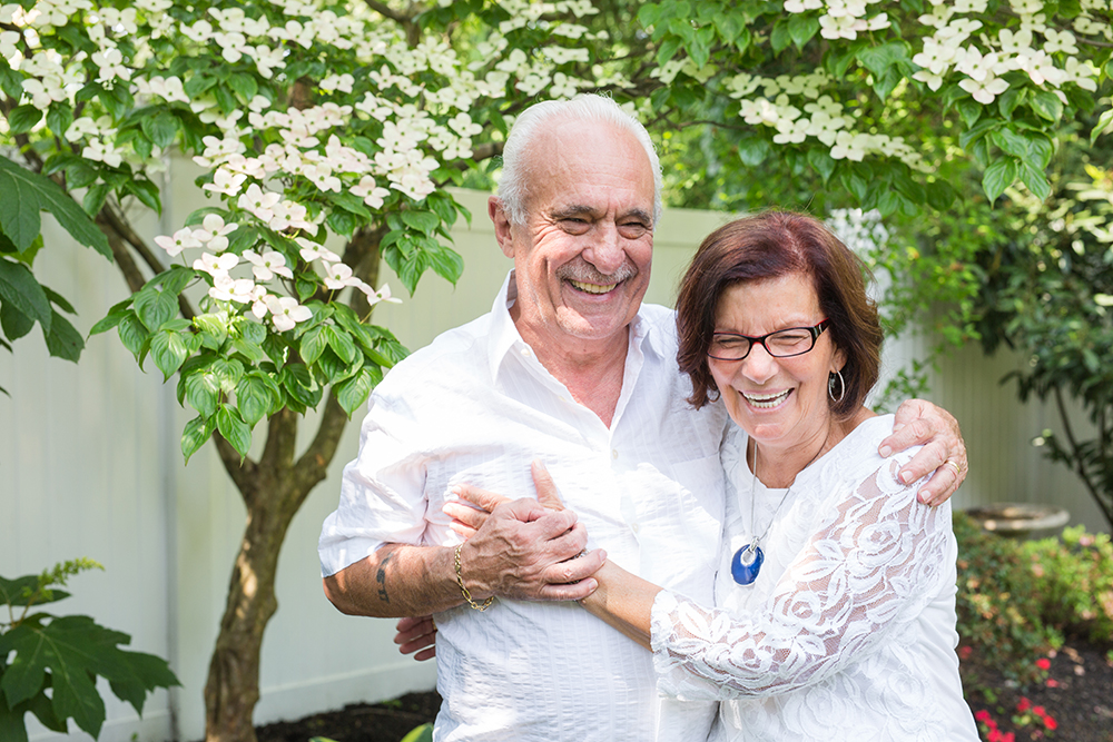 grandparents in love pose in backyard for portrait
