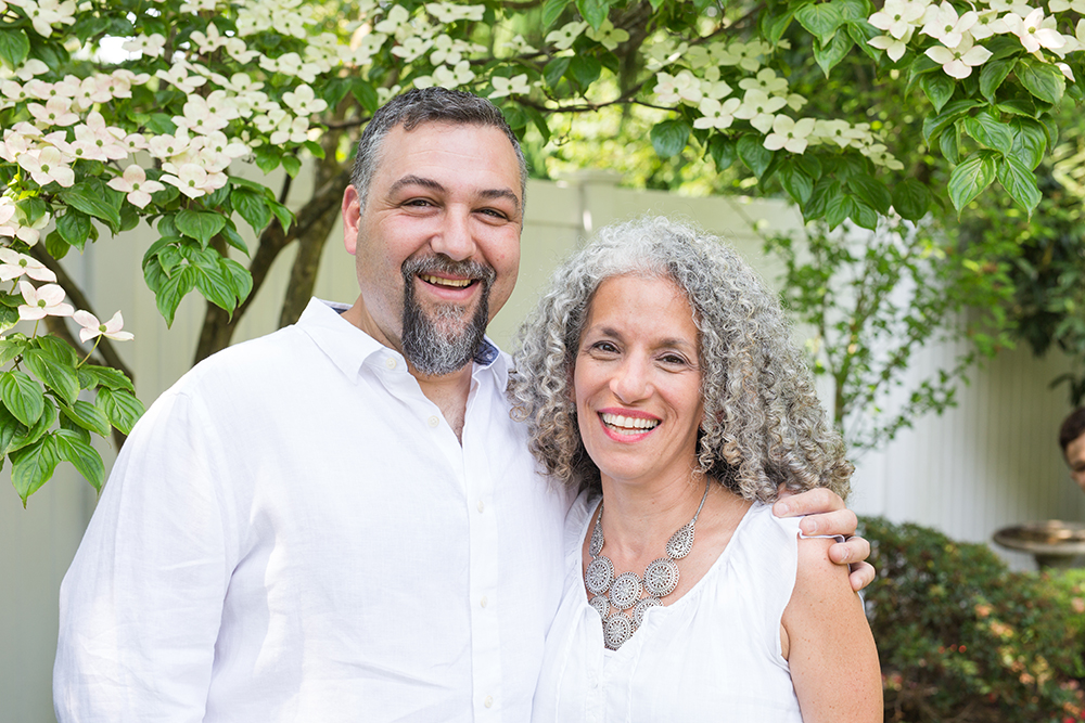 couple poses in backyard for portrait