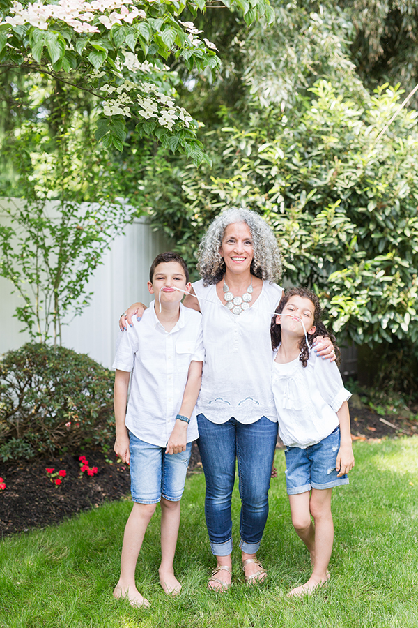 family poses in front yard for family portrait