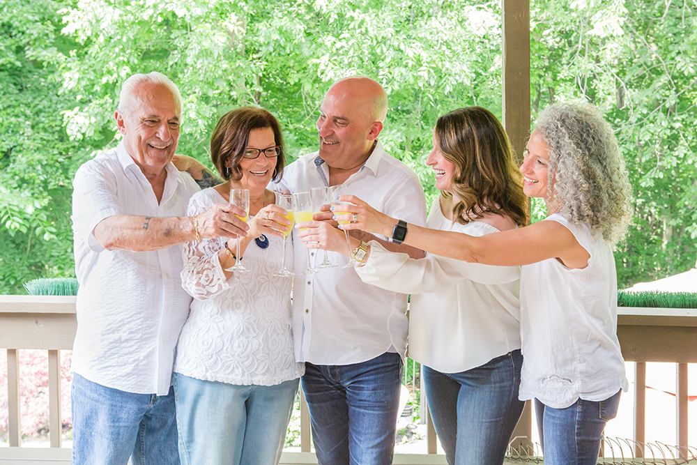 family of 5 cheers mimosas on the back porch