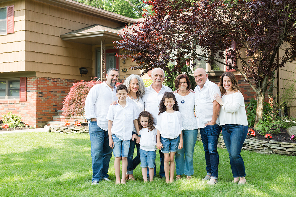 9 family members pose in front of grandparents house