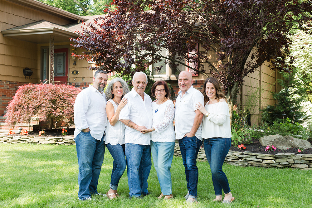 9 family members pose in front of grandparents house