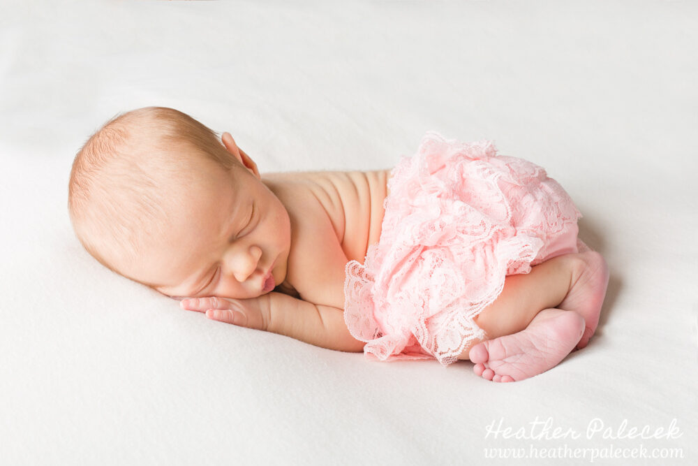 newborn girl in pink diaper cover