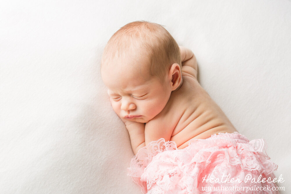 newborn girl in pink diaper cover