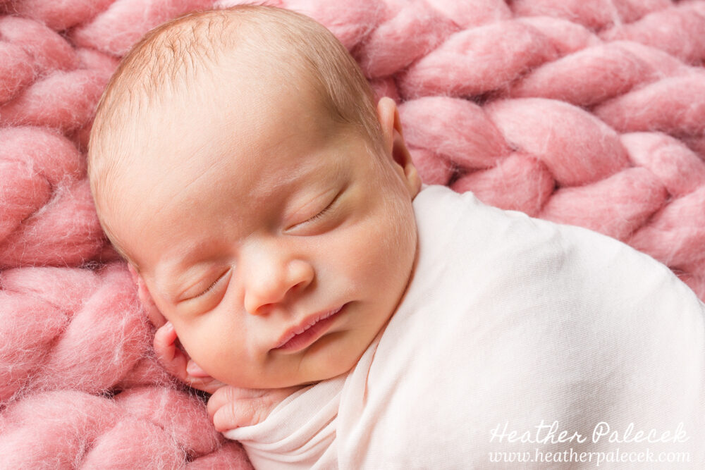 newborn girl posed in pink