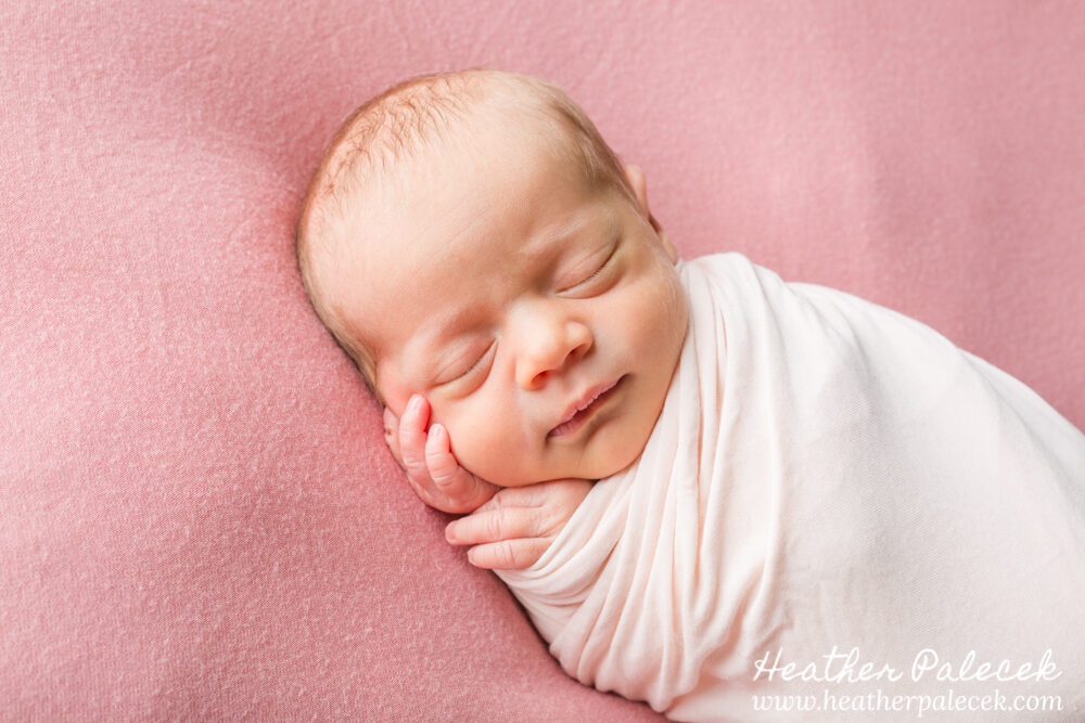 newborn girl posed in pink